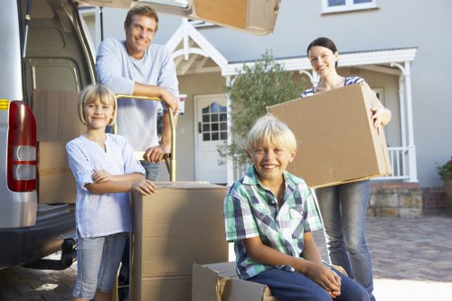 Local moving team transporting a sofa and appliances safely